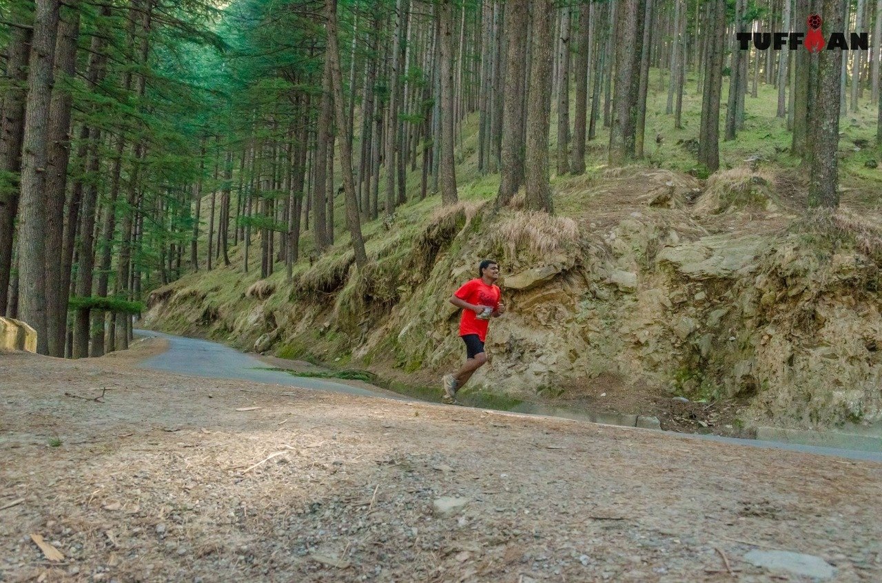 Trail runners climbing a steep Dolomites ridge